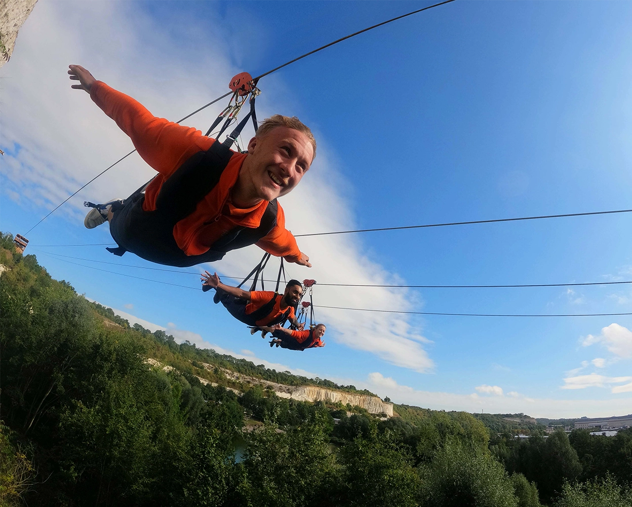 3 people of the zipline experience at hangloose Bluewater with bluewater chalk cliffs